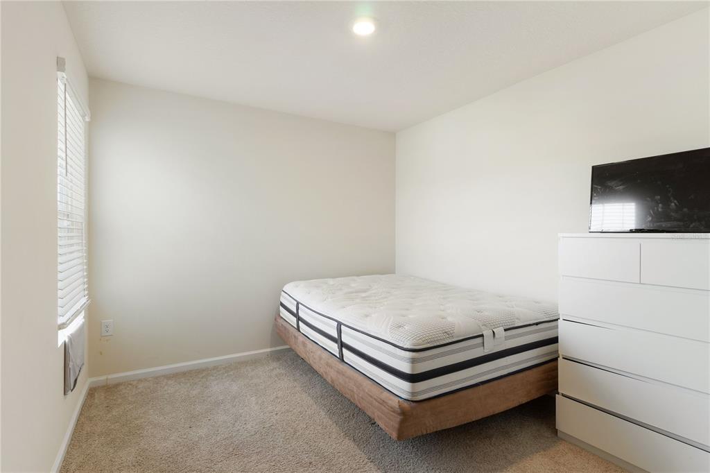 117 Redbud Road Palm Coast, FL 32137 - Photo 11 of 13 a bed sitting in a room next to a window