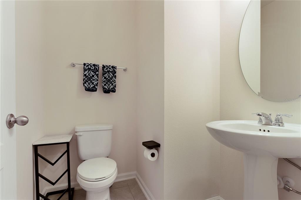 117 Redbud Road Palm Coast, FL 32137 - Photo 12 of 13 a bathroom with a toilet sink and mirror