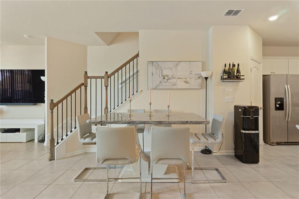 117 Redbud Road Palm Coast, FL 32137 - Photo 5 of 13 a kitchen with stainless steel appliances kitchen island granite countertop a refrigerator and a stove top oven