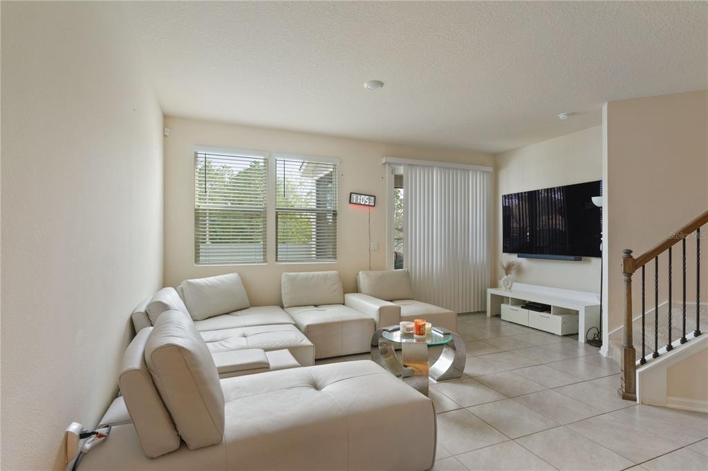 117 Redbud Road Palm Coast, FL 32137 - Photo 6 of 13 a living room with furniture and a flat screen tv