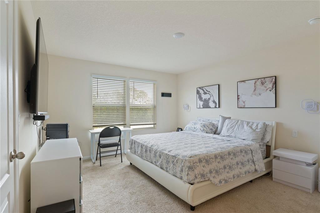 117 Redbud Road Palm Coast, FL 32137 - Photo 7 of 13 a bedroom with a bed and a couch