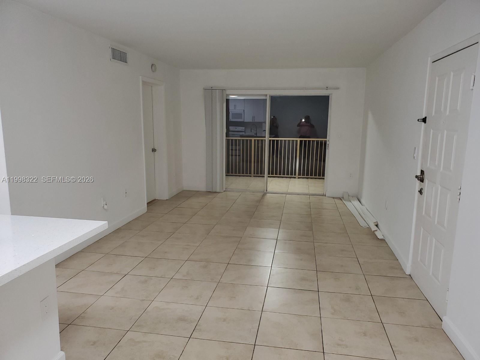 15241 Southwest 80th Street, Unit 307 Miami, FL 33193 - Photo 1 of 13 a view of an empty room with a window