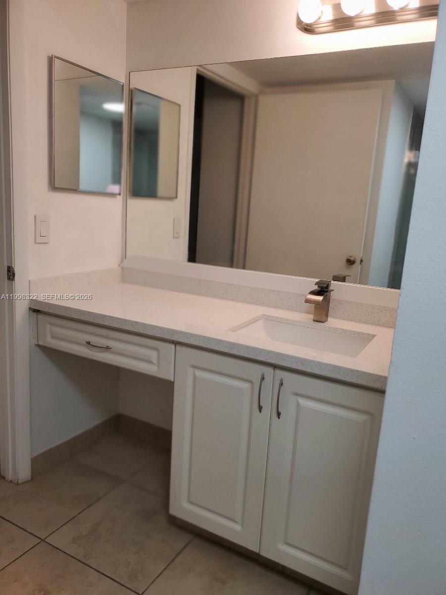 15241 Southwest 80th Street, Unit 307 Miami, FL 33193 - Photo 11 of 13 a bathroom with a sink and a mirror