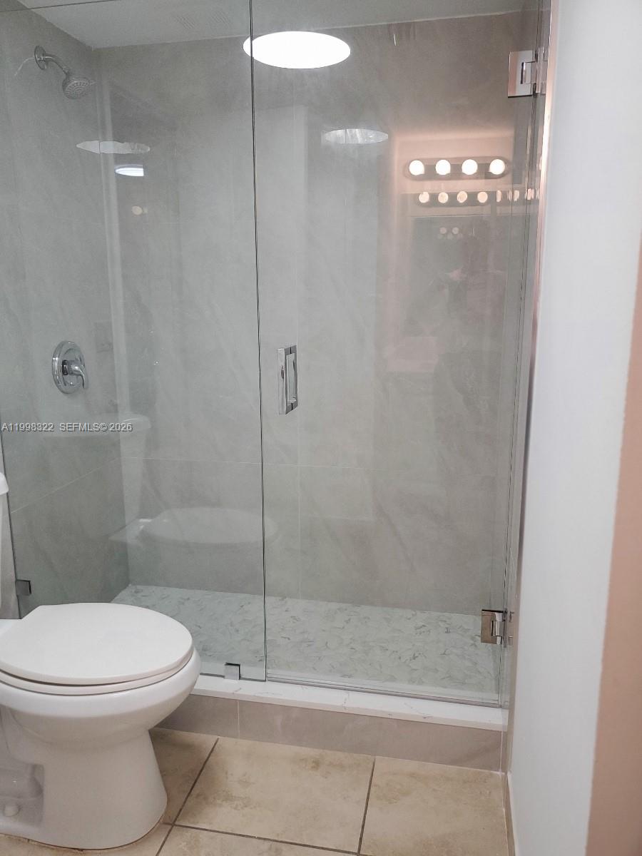 15241 Southwest 80th Street, Unit 307 Miami, FL 33193 - Photo 6 of 13 a bathroom with a shower a toilet and a sink