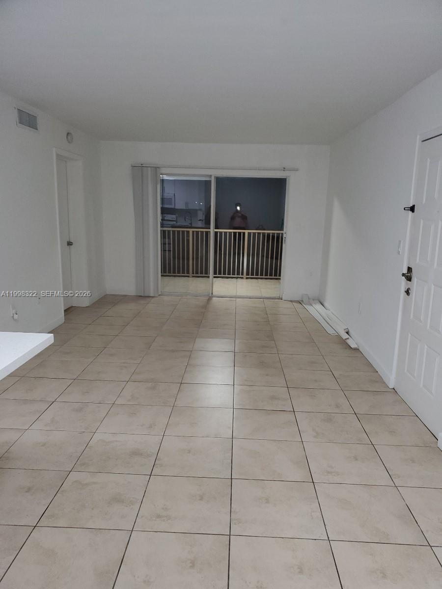 15241 Southwest 80th Street, Unit 307 Miami, FL 33193 - Photo 10 of 13 a view of an empty room with a window