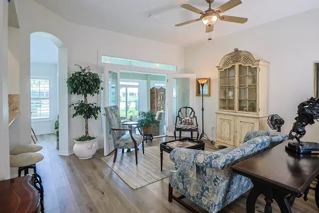a living room with furniture and wooden floor