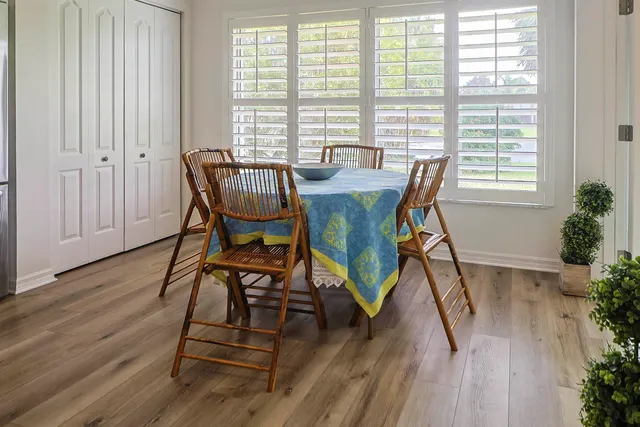 a view of a dining room with furniture and wooden floor