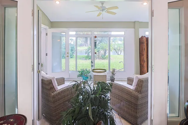 a living room with furniture and a potted plant