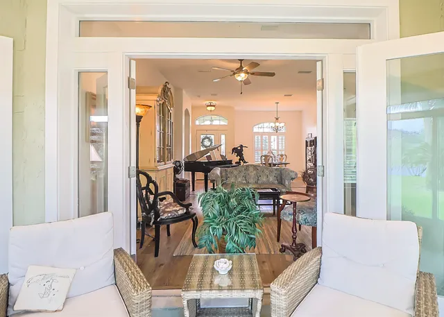a living room with furniture and a floor to ceiling window