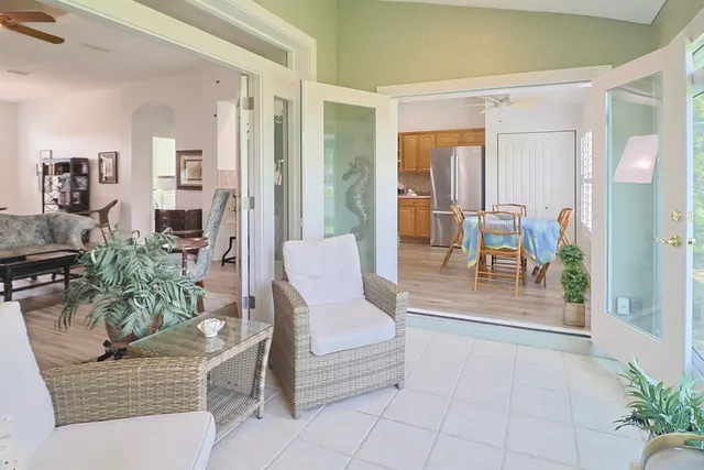 a living room with furniture and a floor to ceiling window