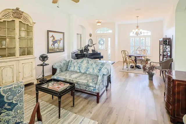 a living room with furniture and wooden floor