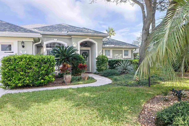 a view of a house with a yard and plants