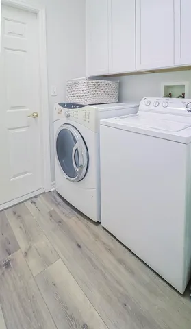 a kitchen with stainless steel appliances white cabinets and a sink