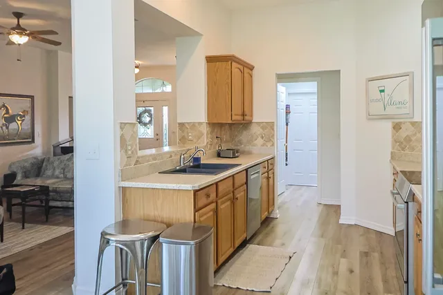 a bedroom with a bed a book shelf and a window
