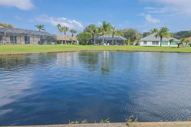a view of a lake with houses in the background