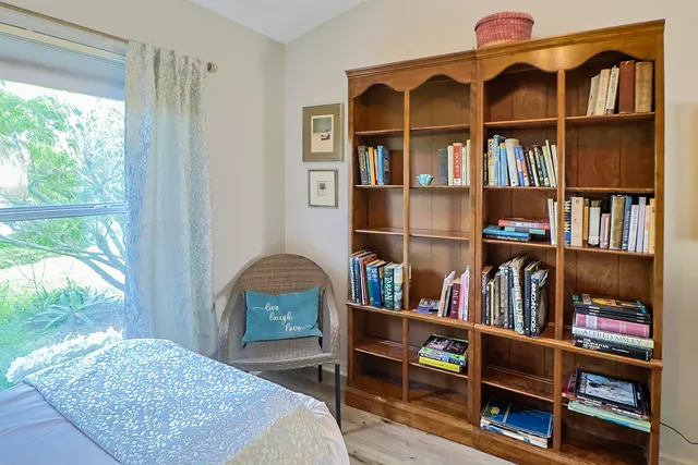 a view of a workspace with furniture and a window