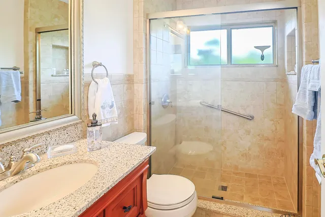 a bathroom with a toilet and a mirror