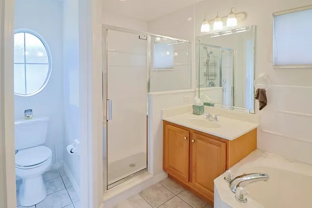 a bedroom with a bed and painting on the wall