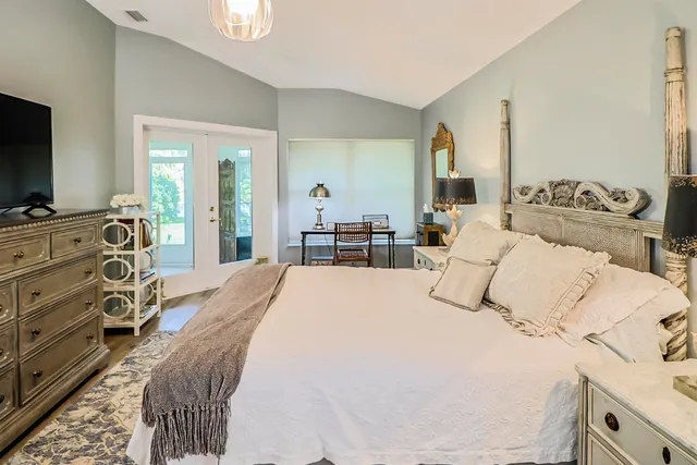 a bedroom with bed chair and window