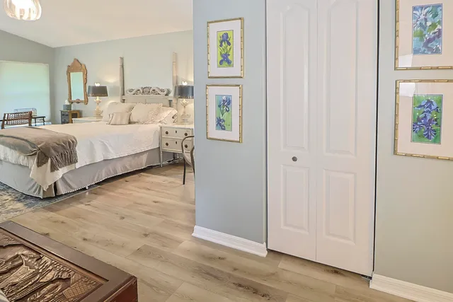 a spacious bedroom with a bed and flat screen tv