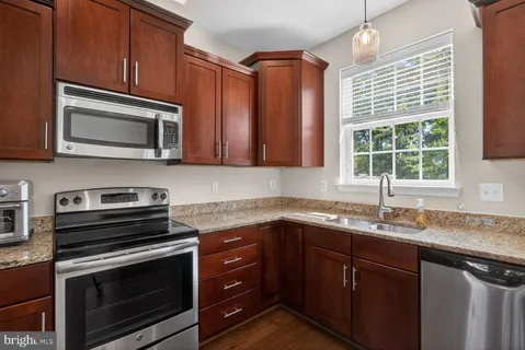 a kitchen with a sink stove and microwave