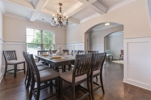 a living room with furniture or chandelier and a wooden floor