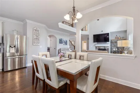 a kitchen with granite countertop cabinets stainless steel appliances and a window