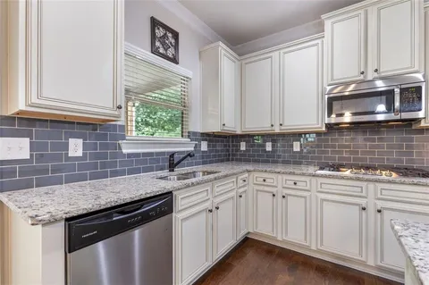 a living room with large windows and wooden floor