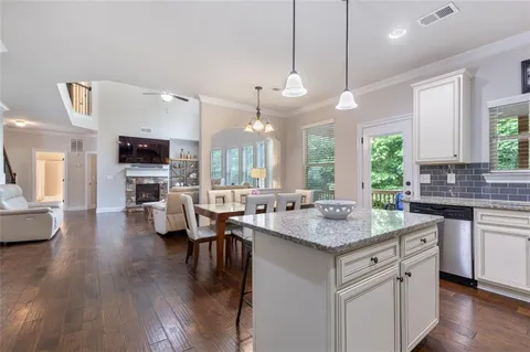 a view of a hallway with wooden floor and windows