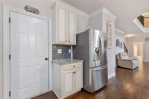 a bedroom with a bed a couch and a flat screen tv
