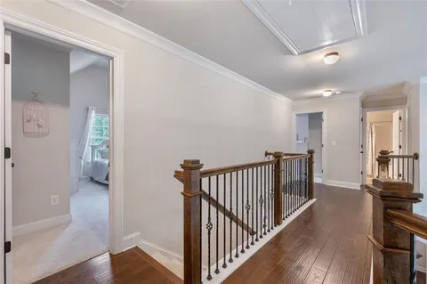 a view of a bedroom with wooden floor and a window