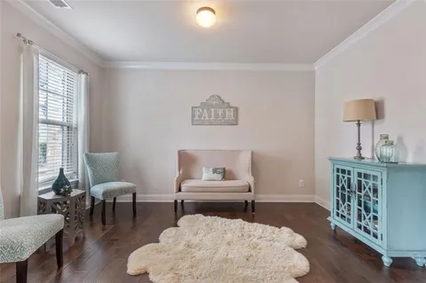 a view of a dining room with furniture a chandelier and wooden floor