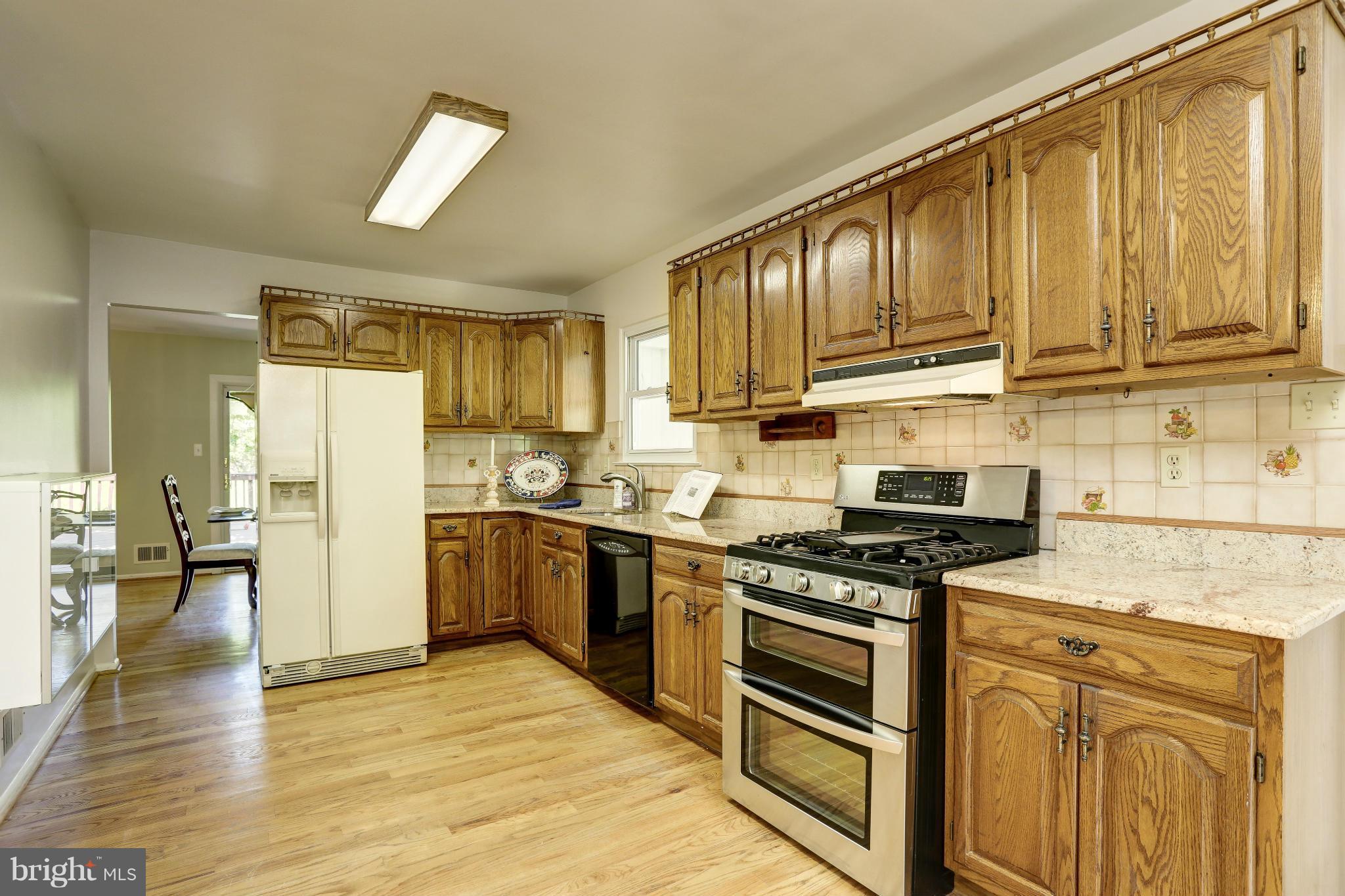 12906 Buccaneer Road Silver Spring, MD 20904 - Photo 11 of 30 a kitchen with stainless steel appliances granite countertop a stove a sink dishwasher and a refrigerator