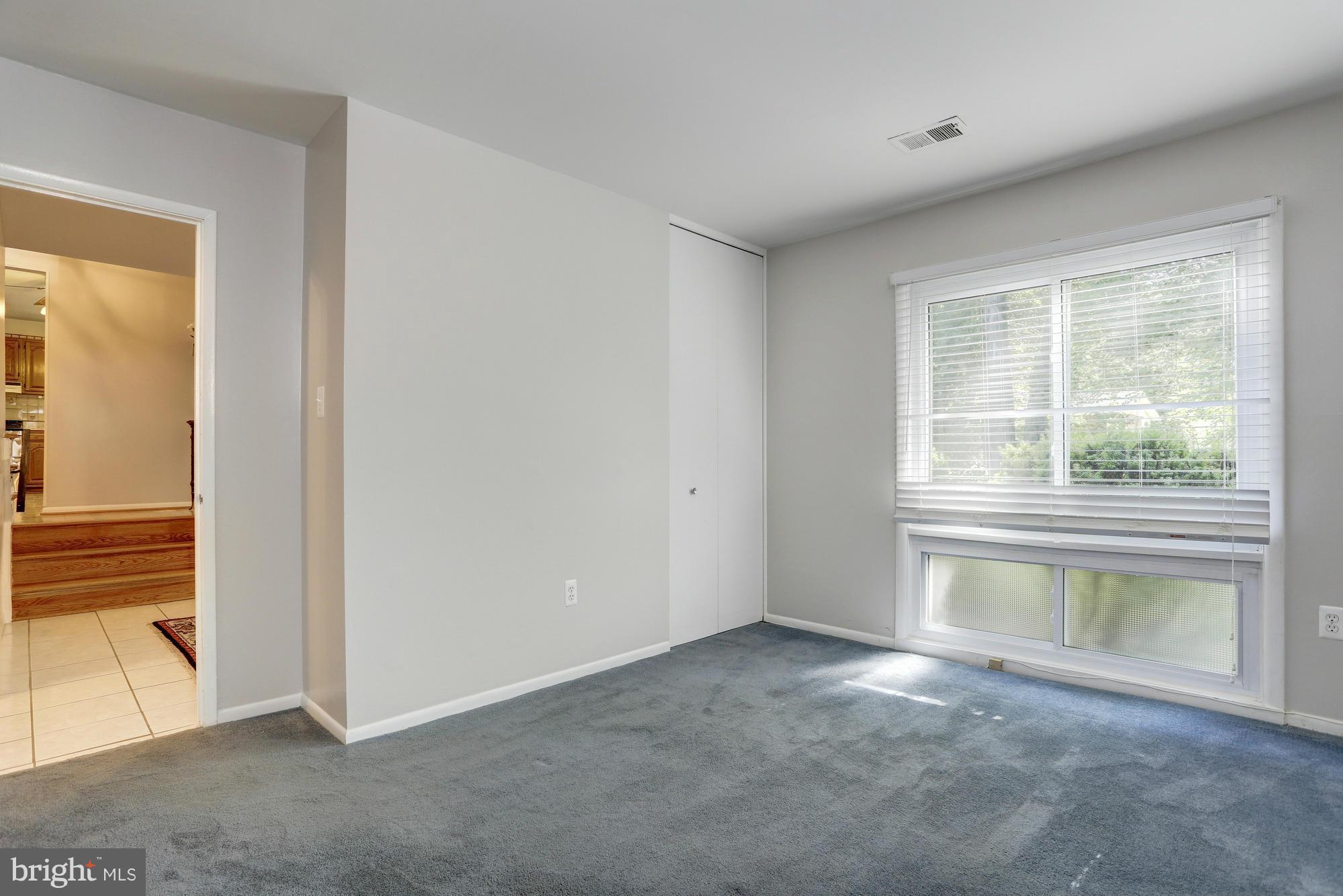 12906 Buccaneer Road Silver Spring, MD 20904 - Photo 15 of 30 an empty room with a fireplace and windows