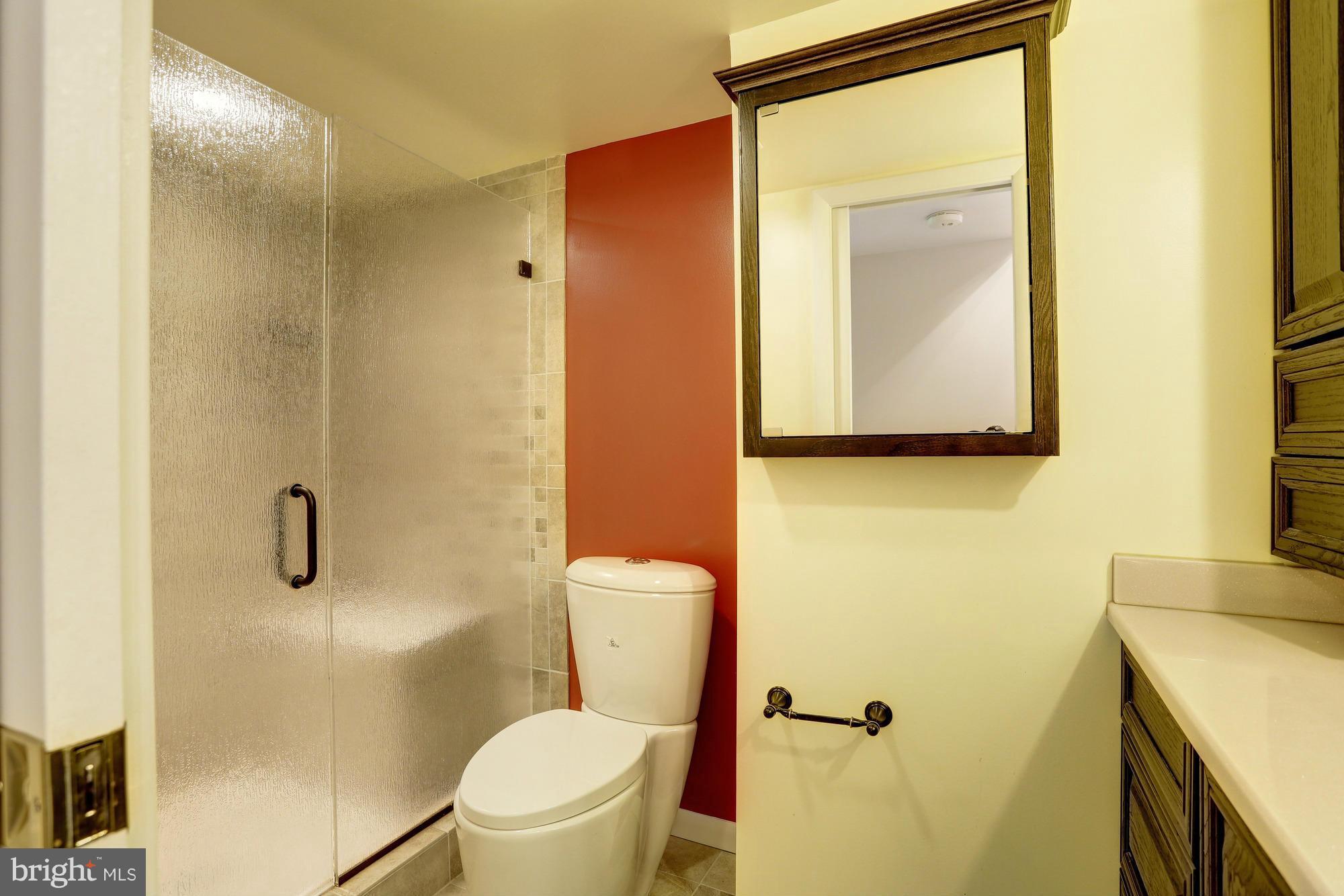12906 Buccaneer Road Silver Spring, MD 20904 - Photo 25 of 30 a bathroom with a toilet sink and mirror