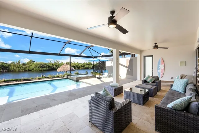 a living room with patio furniture and a floor to ceiling window