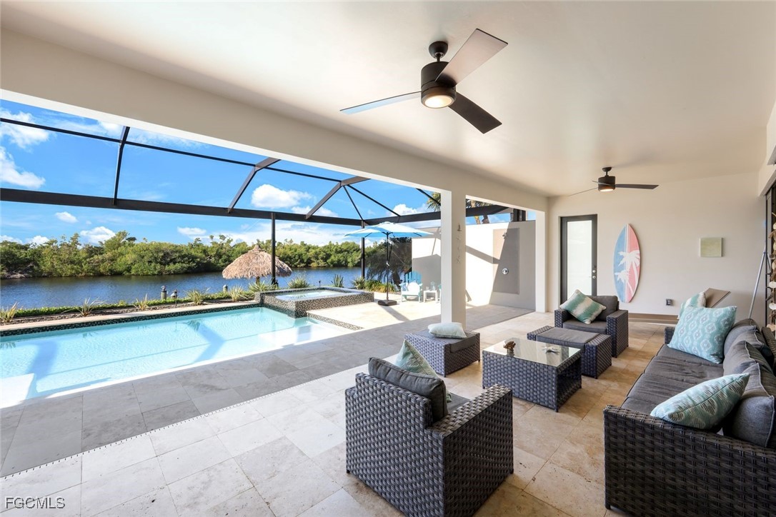 2906 Southwest 29th Terrace Cape Coral, FL 33914 - Photo 15 of 49 a living room with patio furniture and a floor to ceiling window
