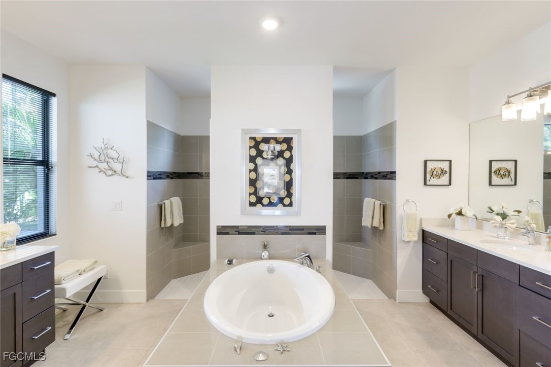 2906 Southwest 29th Terrace Cape Coral, FL 33914 - Photo 18 of 49 a bathroom with a sink a toilet and a bathtub