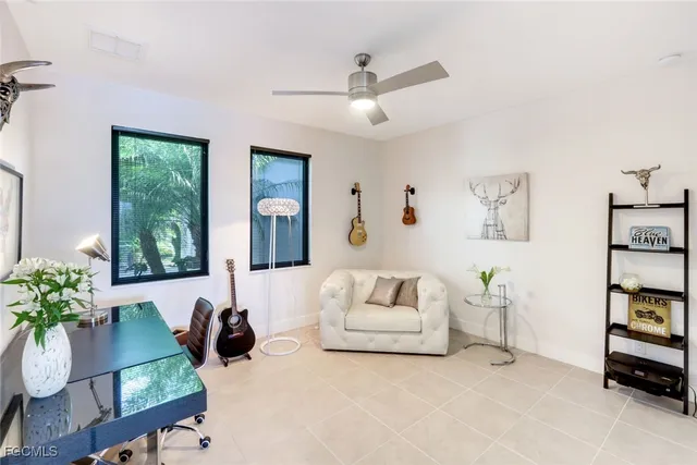 a living room with furniture and a potted plant