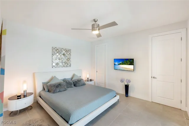 a bedroom with a bed and a painting on the wall