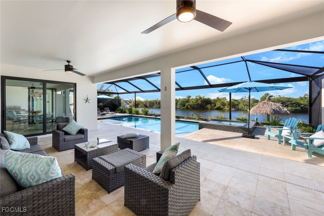 2906 Southwest 29th Terrace Cape Coral, FL 33914 - Photo 28 of 49 a outdoor space with patio the couches and flat screen tv