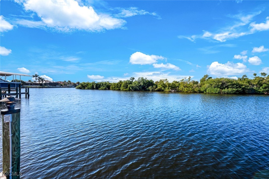 2906 Southwest 29th Terrace Cape Coral, FL 33914 - Photo 36 of 49 a view of a lake with a building in the background