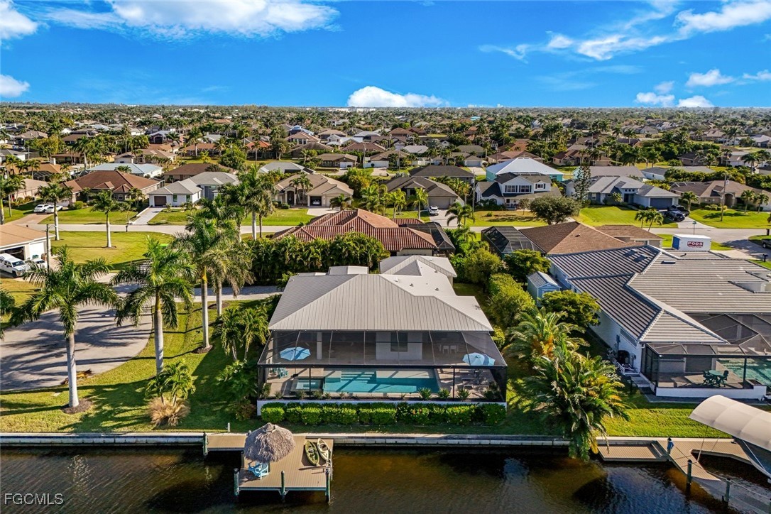 2906 Southwest 29th Terrace Cape Coral, FL 33914 - Photo 44 of 49 an aerial view of residential houses with outdoor space and lake view