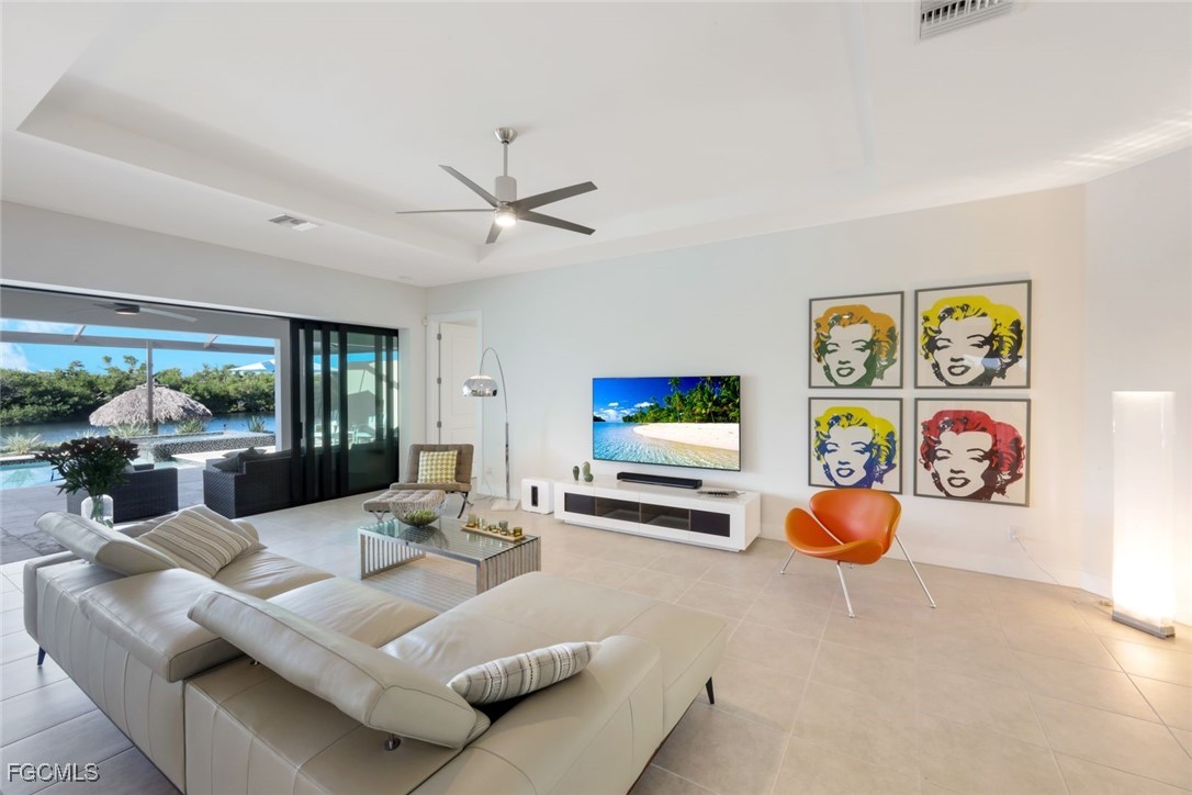 2906 Southwest 29th Terrace Cape Coral, FL 33914 - Photo 8 of 49 a living room with furniture and a flat screen tv