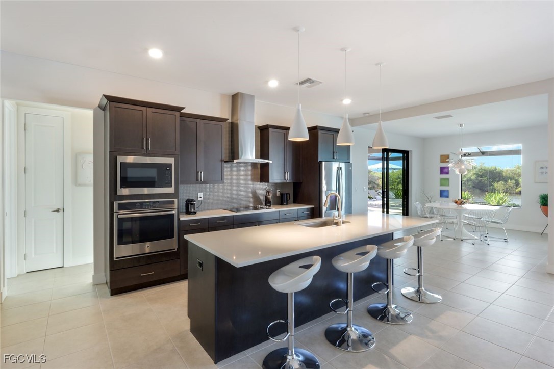 2906 Southwest 29th Terrace Cape Coral, FL 33914 - Photo 9 of 49 a kitchen with a table and chairs in it