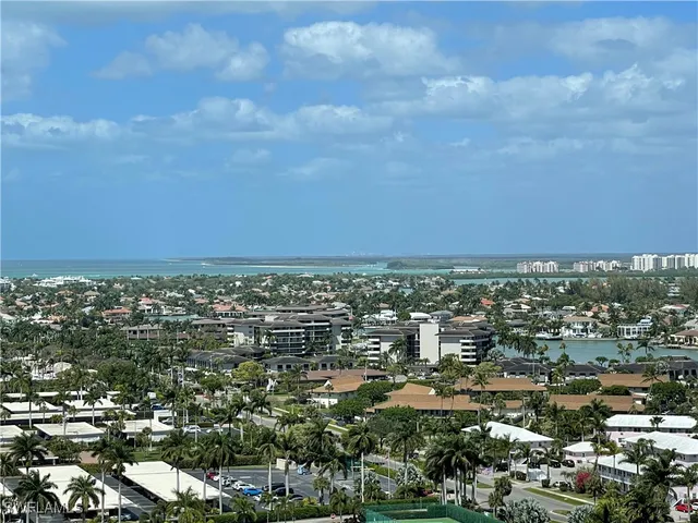 a view of a yard with wooden fence