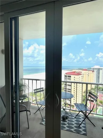 a living room with furniture windows and a table
