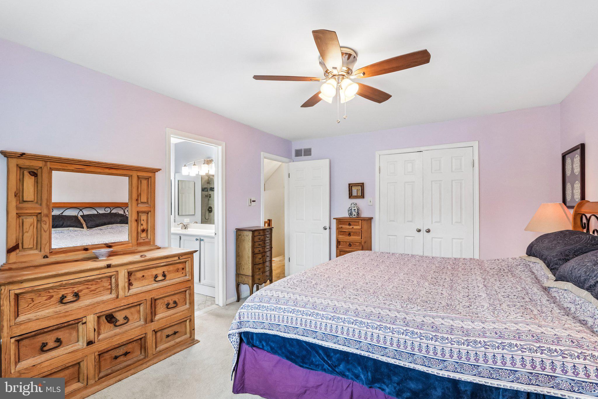 36 Independence Place, Unit 36 Chesterbrook, PA 19087 - Photo 19 of 55 a bedroom with a bed a dresser and a chandelier