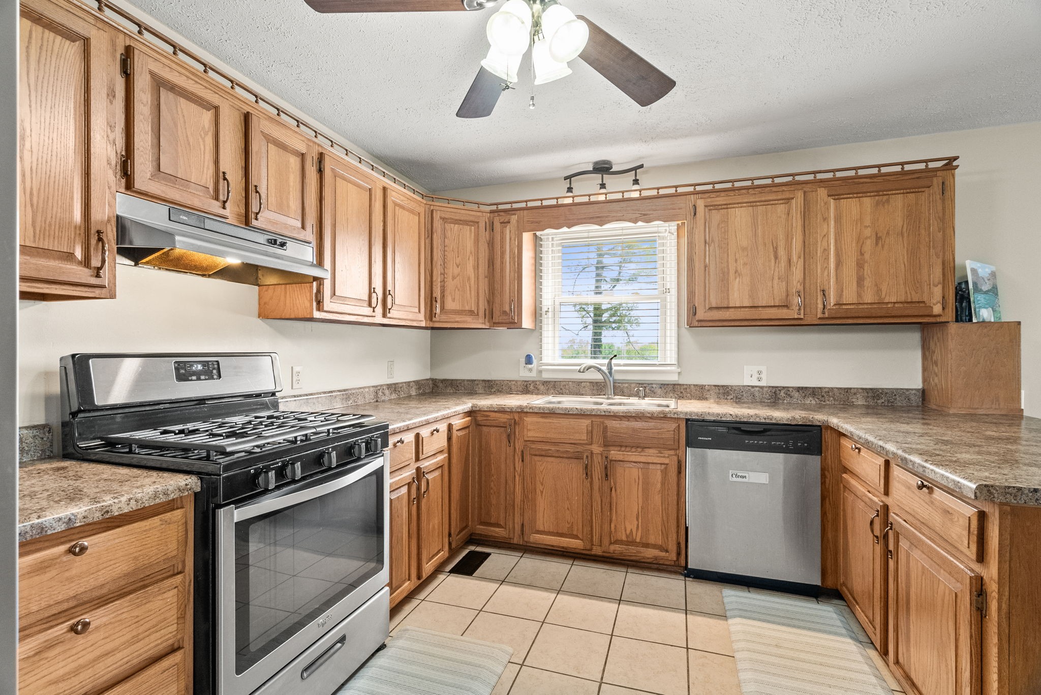 674 Lakeside Drive Springfield, TN 37172 - Photo 14 of 44 a kitchen with stainless steel appliances granite countertop a stove sink and cabinets