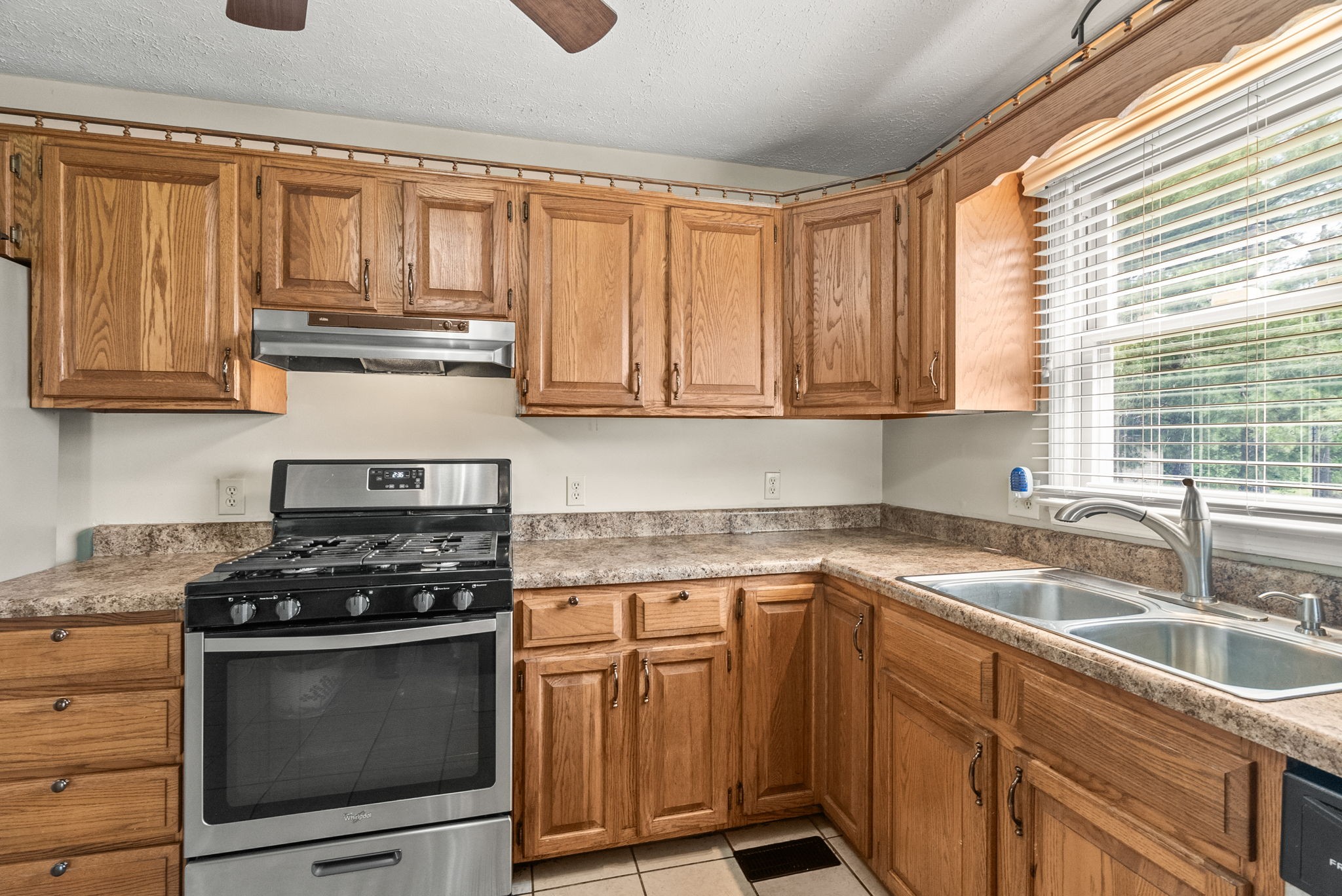 674 Lakeside Drive Springfield, TN 37172 - Photo 15 of 44 a kitchen with granite countertop a sink stainless steel appliances wooden cabinets and a window